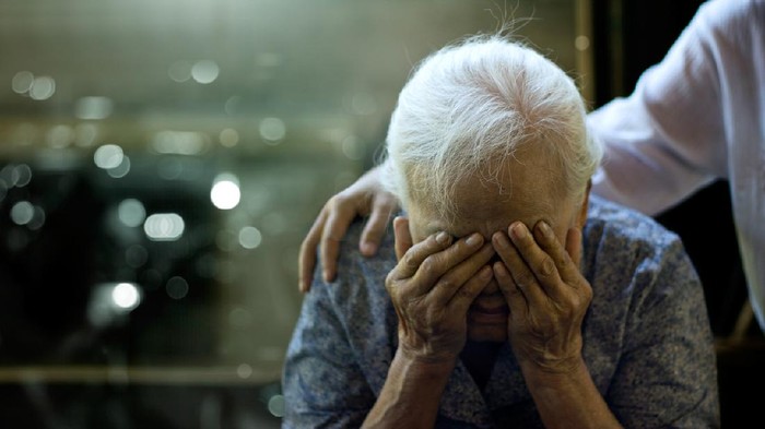 The daughter is comforting an elderly woman who is a mother sadness with Alzheimers disease and amnesia, Memory loss due to dementia.