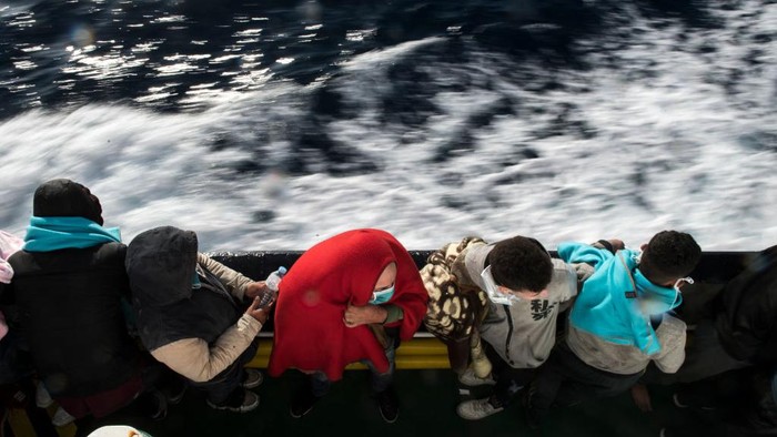 AT SEA - MARCH 29: Two lifeguards from the Spanish NGO Open Arms approach a wooden boat to rescue 84 migrants of different nationalities on March 29, 2021 in At Sea, Unspecified. The Spanish NGO Open Arms rescued passengers in two wooden boats, with 84 and 97 people respectively. The Open Arms vessel now has a total of 219 migrants, rescued in the Malta SAR (Search and Rescue) zone. (Photo by Carlos Gil/Getty Images)