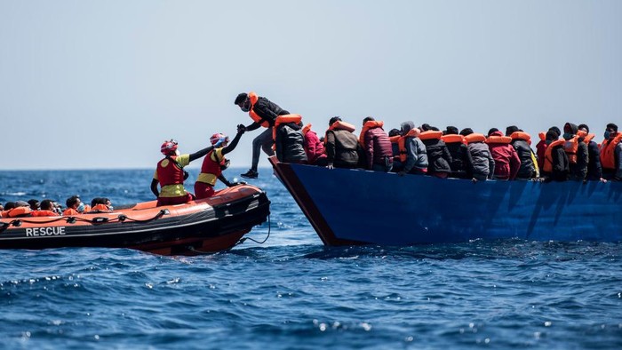 AT SEA - MARCH 29: Two lifeguards from the Spanish NGO Open Arms approach a wooden boat to rescue 84 migrants of different nationalities on March 29, 2021 in At Sea, Unspecified. The Spanish NGO Open Arms rescued passengers in two wooden boats, with 84 and 97 people respectively. The Open Arms vessel now has a total of 219 migrants, rescued in the Malta SAR (Search and Rescue) zone. (Photo by Carlos Gil/Getty Images)