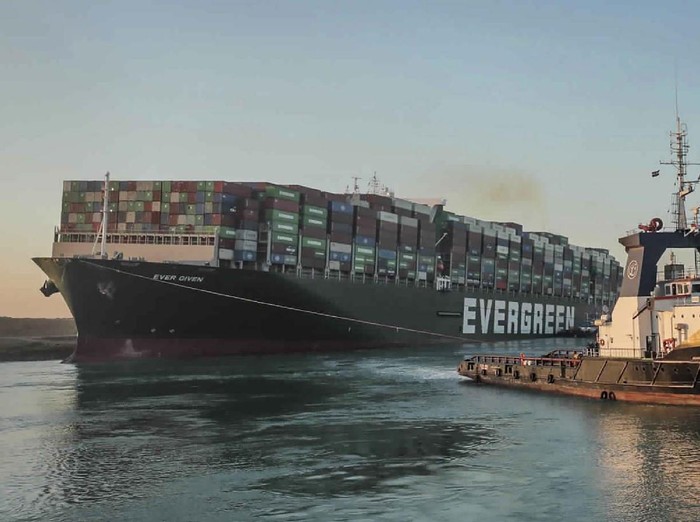In this photo released by Suez Canal Authority, the Ever Given, a Panama-flagged cargo ship is accompanied by Suez Canal tugboats as it moves in the Suez Canal, Egypt, Monday, March 29, 2021. Salvage teams on Monday set free a colossal container ship that has halted global trade through the Suez Canal, bringing an end to a crisis that for nearly a week had clogged one of the worlds most vital maritime arteries. (Suez Canal Authority via AP)