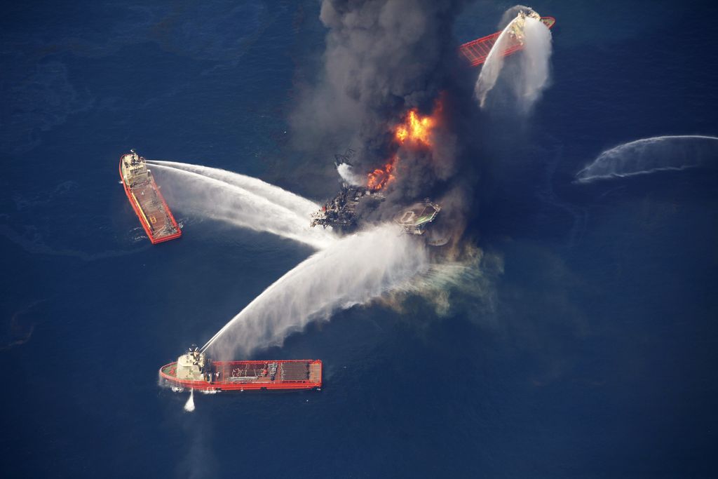 Trump Rollbacks Industry Savings FILE - In this April 21, 2010, file photo, the Deepwater Horizon oil rig burns in the Gulf of Mexico following an explosion that killed 11 workers and caused the worst offshore oil spill in the nation's history. As the Trump administration rolls back environmental and safety rules for the U.S. energy sector, government projections show billions of dollars in savings reaped by companies will come at a steep cost: increased premature deaths and illnesses from air pollution, a jump in climate-warming emissions and more derailments of trains carrying explosive fuels. (AP Photo/Gerald Herbert, File)