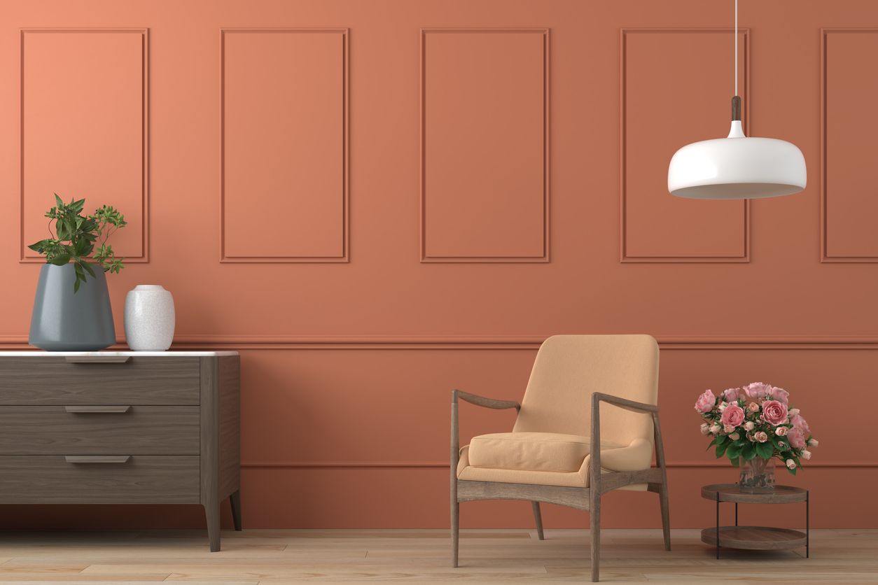 vibrant orange interior design background with peach colored armchair, lamp and cofee table with roses on modern moulding wall, 3d render