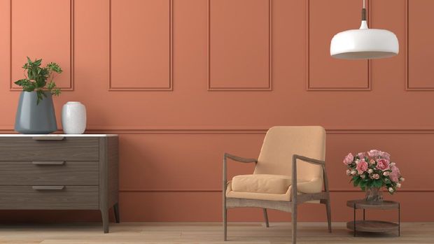 vibrant orange interior design background with peach colored armchair, lamp and cofee table with roses on modern moulding wall, 3d render