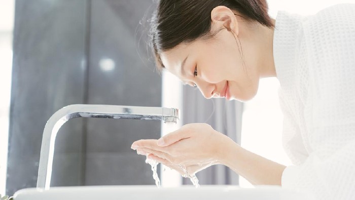 Young Asian WWoman Washing Her Face