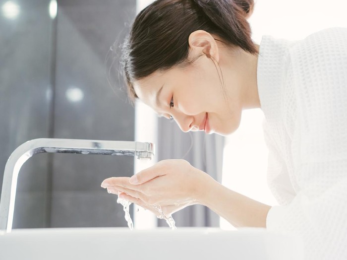 Young Asian WWoman Washing Her Face