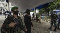 Sejumlah aparat kepolisian bersenjata laras panjang berpatroli di luar area Gereja Katedral Jakarta. 