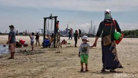Sejumlah pengunjung menikmati Pantai Ancol, Jakarta Utara, Jumat (2/4).
