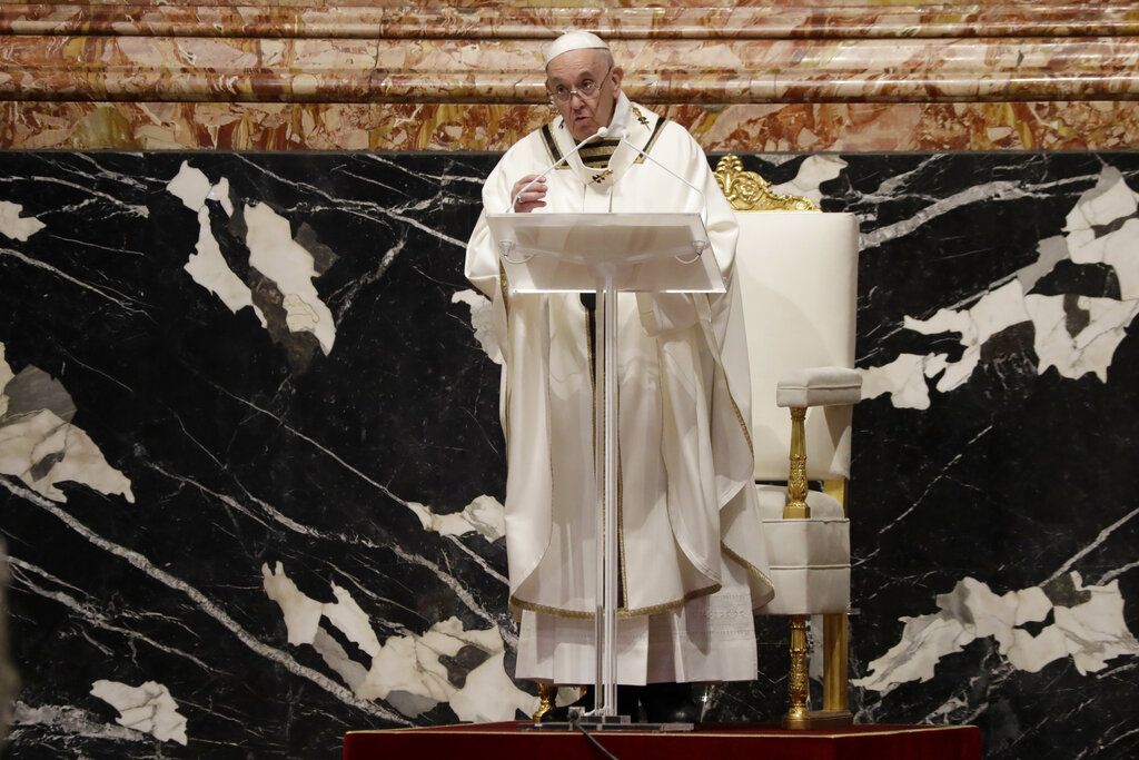 Pope Francis blows inside an amphora containing holy oil during a Chrism Mass inside St. Peter's Basilica, at the Vatican, Thursday, April 1, 2021. During the Mass the Pontiff blesses a token amount of oil that will be used to administer the sacraments for the year. (AP Photo/Andrew Medichini, pool)