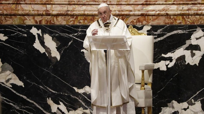 Pope Francis blows inside an amphora containing holy oil during a Chrism Mass inside St. Peters Basilica, at the Vatican, Thursday, April 1, 2021. During the Mass the Pontiff blesses a token amount of oil that will be used to administer the sacraments for the year. (AP Photo/Andrew Medichini, pool)
