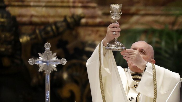 Pope Francis blows inside an amphora containing holy oil during a Chrism Mass inside St. Peters Basilica, at the Vatican, Thursday, April 1, 2021. During the Mass the Pontiff blesses a token amount of oil that will be used to administer the sacraments for the year. (AP Photo/Andrew Medichini, pool)