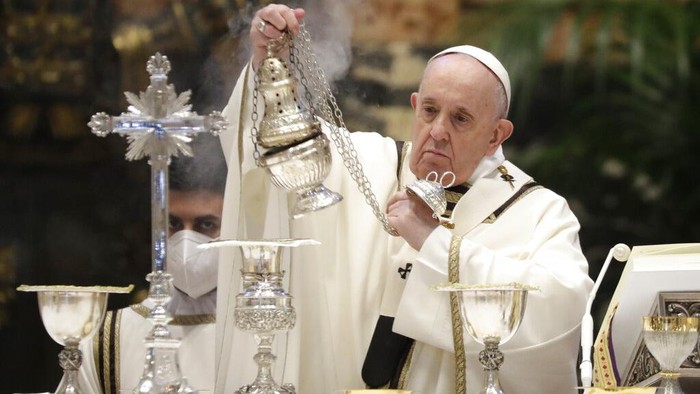 Pope Francis blows inside an amphora containing holy oil during a Chrism Mass inside St. Peters Basilica, at the Vatican, Thursday, April 1, 2021. During the Mass the Pontiff blesses a token amount of oil that will be used to administer the sacraments for the year. (AP Photo/Andrew Medichini, pool)