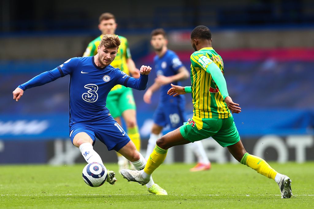 LONDON, ENGLAND - APRIL 03: Timo Werner of Chelsea is challenged by Ainsley Maitland-Niles of West Bromwich Albion during the Premier League match between Chelsea and West Bromwich Albion at Stamford Bridge on April 03, 2021 in London, England. Sporting stadiums around the UK remain under strict restrictions due to the Coronavirus Pandemic as Government social distancing laws prohibit fans inside venues resulting in games being played behind closed doors. (Photo by Clive Rose/Getty Images)