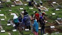 Selain berdoa, mereka juga membersihkan makam keluarga.