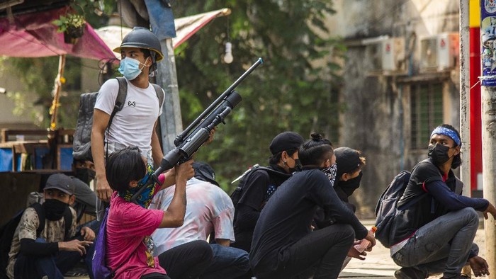Anti-coup protesters aim with homemade air rifle during a protest in Yangon, Myanmar, Saturday, April 3, 2021. Threats of lethal violence and arrests of protesters have failed to suppress daily demonstrations across Myanmar demanding the military step down and reinstate the democratically elected government. (AP Photo)