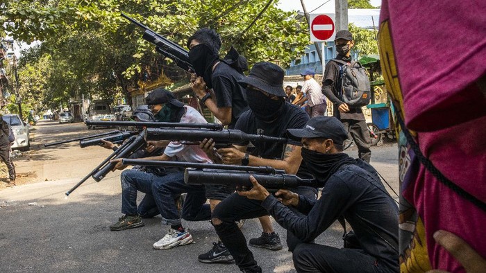 Anti-coup protesters aim with homemade air rifle during a protest in Yangon, Myanmar, Saturday, April 3, 2021. Threats of lethal violence and arrests of protesters have failed to suppress daily demonstrations across Myanmar demanding the military step down and reinstate the democratically elected government. (AP Photo)