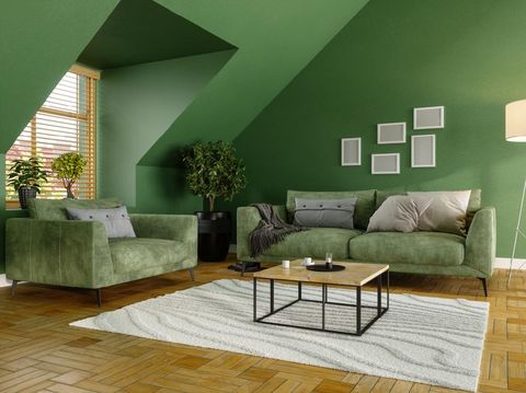 Green Living Room With Green Sofa, Coffee Tables and Plants