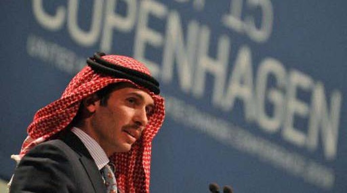 Jordanian Prince Hamzah bin al-Hussein, president of the Royal Aero Sports Club of Jordan, carries a parachute during a media event to announce the launch of 