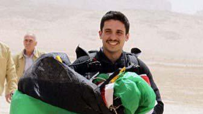 Jordanian Prince Hamzah bin al-Hussein, president of the Royal Aero Sports Club of Jordan, carries a parachute during a media event to announce the launch of 