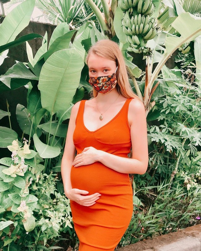 Sambil memegang perut, Polly Alexandria tampak memakai masker dan dress warna terracota, saat sedang berada di kebun. Warganet pun mendoakan kehamilan Polly lancar. Ihhh gak sabar nanti baby nya mirip siapa ,,, sehat trs ya bumil lancar sampai lahiran, ucap @ila_minho17. Aaaaa selamat, semoga sehat selalu, tutur akun @werdosjtmk. Foto: Dok. Instagram @pollyoddsocks.