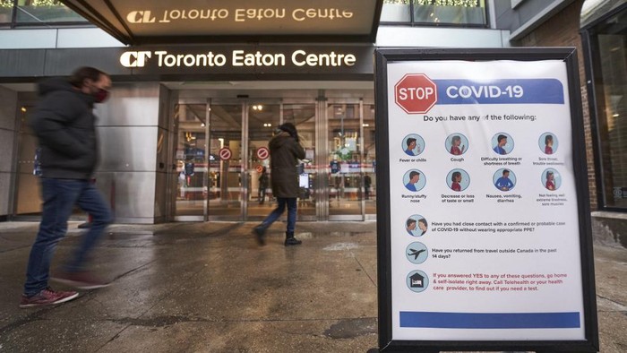 (FILES) In this file photo people arrive at the entrance to the Toronto Eaton Centre in downtown Toronto, Ontario on November 23, 2020, the first day of a new lockdown in the city. - Ontario Premier Doug Ford announced on April 1, 2021 strict measures for all of April in Canadas most populous province to slow a surge in Covid-19 cases, but stopped short of a total lockdown.The shutdown of most stores and severe limits on services in the province of 14 million people is to start on Saturday and last for at least 28 days. 
