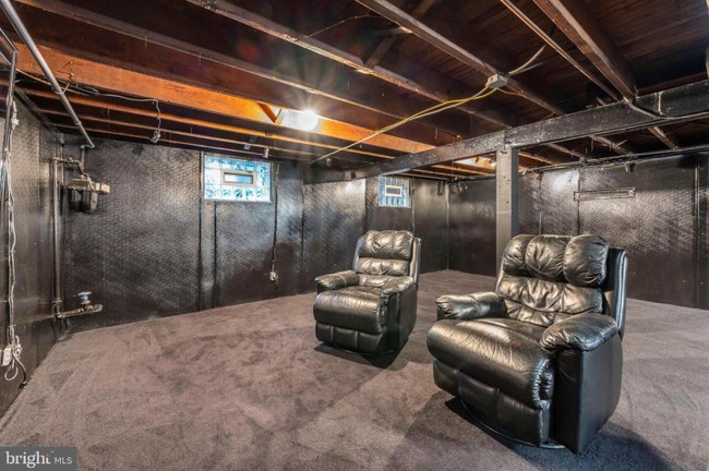 Rumah ini juga memiliki ruang bawah tanah. Ruang bawah tanahnya didominasi dengan warna hitam. Terdapat dua buah sofa kulit berwarna hitam yang diletakkann di depan TV. Foto: realtor.com