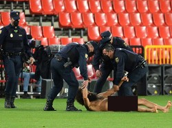 Tak pakai lama, pria bugil itu langsung dikepung petuugas pertandingan Granada vs MU. (Foto: Cristina Quicler/AFP/Edit)
