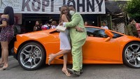Setelah asyik mengobrol, Hotman Paris tak lupa foto di depan Kopi Johny. Kali ini ia kembali ditemani cewek cantik dan mobil sport mahal. Foto: Instagram hotmanparisofficial