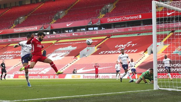 Liverpool's Mohamed Salah scores his side's opening goal during the English Premier League soccer match between Liverpool and Aston Villa at Anfield stadium in Liverpool, England, Saturday, April 10, 2021. (Clive Brunskill/Pool via AP)