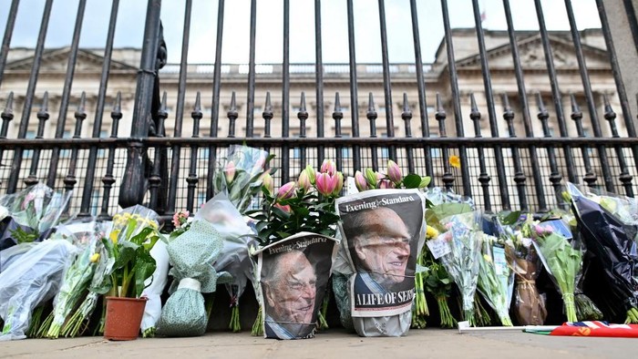 Floral tributes are pictured at the gates of Buckingham Palace in central London on April 9, 2021 after the announcement of the death of Britains Prince Philip, Duke of Edinburgh. - Queen Elizabeth IIs husband Prince Philip, who recently spent more than a month in hospital and underwent a heart procedure, died on April 9, 2021, Buckingham Palace announced. He was 99. (Photo by JUSTIN TALLIS / AFP)