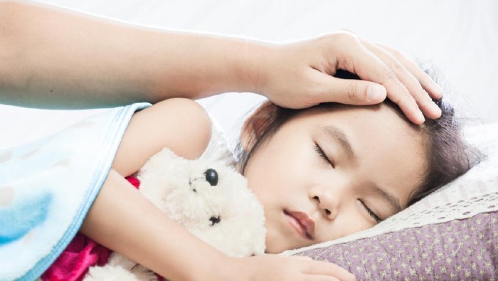 anak sakit Mother hand holding sick daughter hand who have IV solution bandaged with love and care while she is sleeping on bed in the hospital