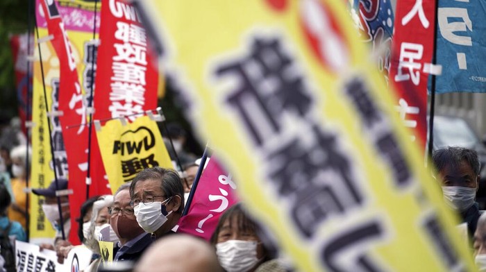 Japan Nuclear Fukushima Water Protest People protest against government's decision to start releasing massive amounts of treated radioactive water from the wrecked Fukushima nuclear plant into the sea, during a rally outside the prime minister's office in Tokyo Tuesday, April 13, 2021. The decision, long speculated but delayed for years due to safety concerns and protests, came at a meeting of Cabinet ministers who endorsed the ocean release as the best option. Signs mean