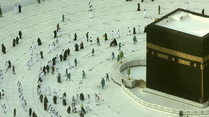 Muslim pilgrims pray around the Kaaba, the cubic building at the Grand Mosque, as they keep social distancing during the minor pilgrimage, known as Umrah, marking the holy month of Ramadan, in the Muslim holy city of Mecca, Saudi Arabia, Monday, April 12, 2021. During Ramadan, the holiest month in Islamic calendar, Muslims refrain from eating, drinking, smoking and sex from dawn to dusk. (AP Photo/Amr Nabil)