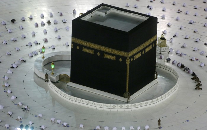 Muslim pilgrims pray around the Kaaba, the cubic building at the Grand Mosque, as they keep social distancing during the minor pilgrimage, known as Umrah, marking the holy month of Ramadan, in the Muslim holy city of Mecca, Saudi Arabia, Monday, April 12, 2021. During Ramadan, the holiest month in Islamic calendar, Muslims refrain from eating, drinking, smoking and sex from dawn to dusk. (AP Photo/Amr Nabil)