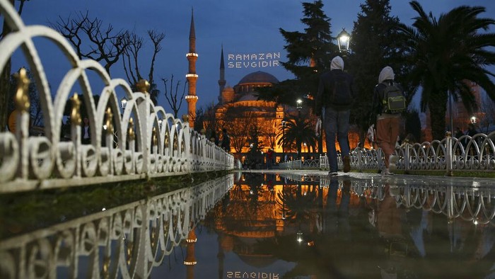 A street vendor waits for clients near the iconic Haghia Sophia, in the historic Sultan Ahmed district of Istanbul Tuesday, April 13, 2021. As Muslims around the world began marking Ramadan Tuesday, in mostly-Muslim Turkey, the month of fasting kicked off with some restrictions amid record levels of COVID-19 infections.(AP Photo/Emrah Gurel)
