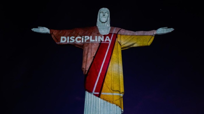 RIO DE JANEIRO, BRAZIL - APRIL 14: View of the statue of Christ the Redeemer illuminated with the projection of the word respect on April 14, 2021 in Rio de Janeiro, Brazil. The projections are a tribute by the Brazilian Olympic Committee to mark 100 days until the Tokyo Olympic Games 2021 and to remind everyone of how sports can inspire in the fight against COVID-19. In addition to the colors of the Brazilian delegation's uniform, background images of pools, tatami mats and courts will be projected. (Photo by Wagner Meier/Getty Images)