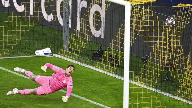 Manchester City's goalkeeper Ederson fails to save a shot by Dortmund's Jude Bellingham during the Champions League quarterfinal second leg soccer match between Borussia Dortmund and Manchester City at the Signal Iduna Park stadium in Dortmund, Germany, Wednesday, April 14, 2021. (Federico Gambarini/Pool via AP)