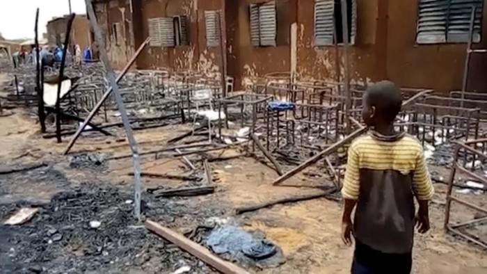 This image taken from Associated Press video, shows burnt chairs, tables and other objects in the school, in Niamey, Niger, Wednesday April 14, 2021. Hospital officials say a fire at an elementary school in Niger's capital has killed 20 children. It was not immediately known what started the fire on Tuesday afternoon but authorities said that high winds in the area allowed the blaze to spread rapidly. (AP Photo/Boureima Issoufou)