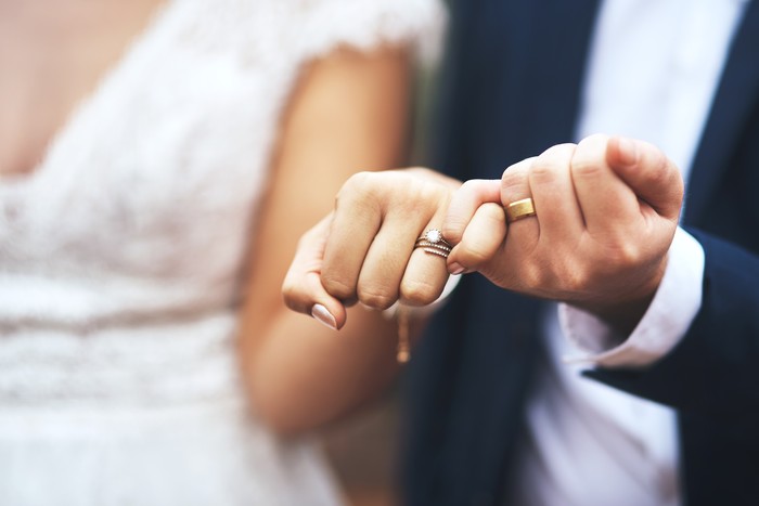 1181587386 Cropped shot of an unrecognizable newlywed couple doing a pinky swear gesture on their wedding day