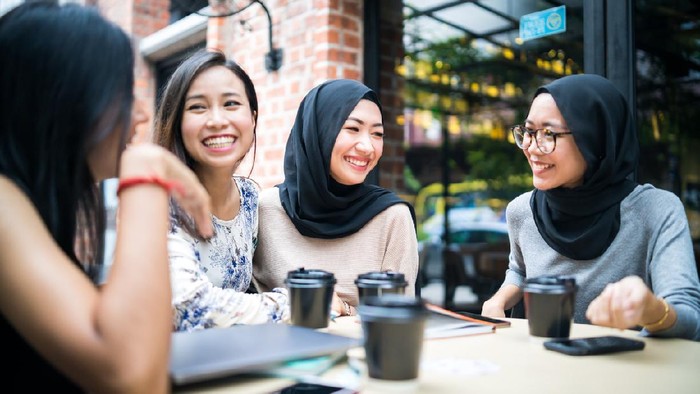 Young Malaysian girls talking to each other and enjoy the gathering.