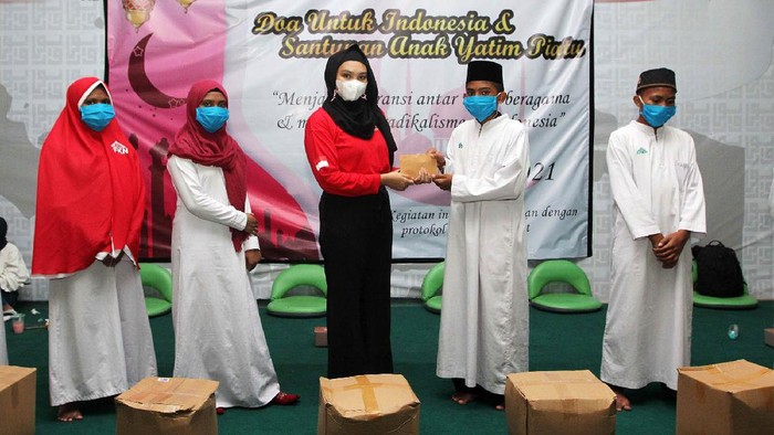 Doa dan Santunan Anak Yatim Piatu Ketua Koordinator Aliansi Aktivis dan Mahasiswa (Aman) Indonesia Ginka Febriyanti memberikan santunan kepada yatim piatu di Pondok Pesantren Al Fatih Kaaffah Nusantara, Bekasi, Jawa Barat, Jumat (16/4/21). Ratusan yatim piatu berdoa untuk Indonesia dalam rangka menjaga toleransi antar umat beragama dan memerangi radikalisme di Indonesia.