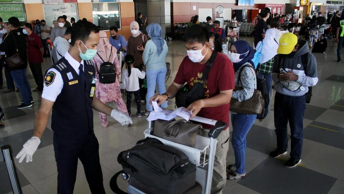 KESIAPAN BANDARA ANTISIPASI LONJAKAN PENUMPANG Sejumlah calon penumpang berjalan masuk ke dalam terminal keberangkatan di Bandara Internasional Sultan Hasanuddin, Maros, Sulawesi Selatan, Minggu (18/4/2021). Pihak bandara setempat mengaku telah siap mengantisipasi lonjakan penumpang jelang berlakunya pelarangan mudik oleh pemerintah pada 6-17 Mei 2021 dengan menerapkan protokol kesehatan COVID-19 secara ketat. ANTARA FOTO/Arnas Padda/yu/aww.