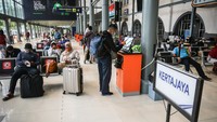 Penumpang menunggu kereta api di Stasiun Pasar Senen, Jakarta, Minggu (18/4/2021).