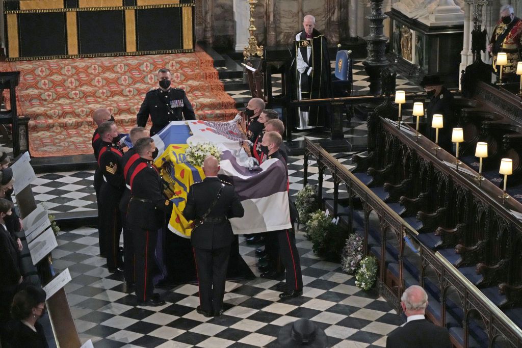 Britain's Queen Elizabeth II follows the coffin in a car as it makes it's way past the Round Tower during the funeral of Britain's Prince Philip inside Windsor Castle in Windsor, England Saturday April 17, 2021. (Leon Neal/Pool via AP)