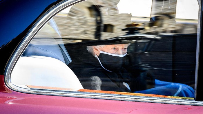 Britains Queen Elizabeth II follows the coffin in a car as it makes its way past the Round Tower during the funeral of Britains Prince Philip inside Windsor Castle in Windsor, England Saturday April 17, 2021. (Leon Neal/Pool via AP)