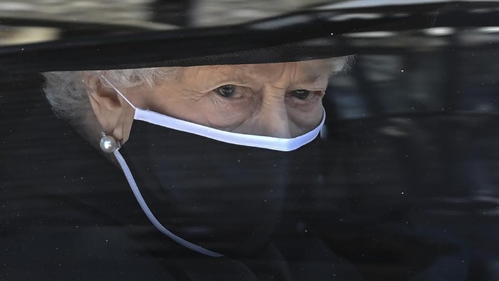 Britains Queen Elizabeth II follows the coffin in a car as it makes its way past the Round Tower during the funeral of Britains Prince Philip inside Windsor Castle in Windsor, England Saturday April 17, 2021. (Leon Neal/Pool via AP)