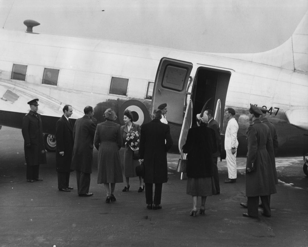 Princess Elizabeth (centre, holding a bouquet of flowers) saying goodbye to a group of people as she boards the King's Flight for Malta to join Prince Philip, at London Airport, March 28th 1950. (Photo by Don Price/Fox Photos/Getty Images)