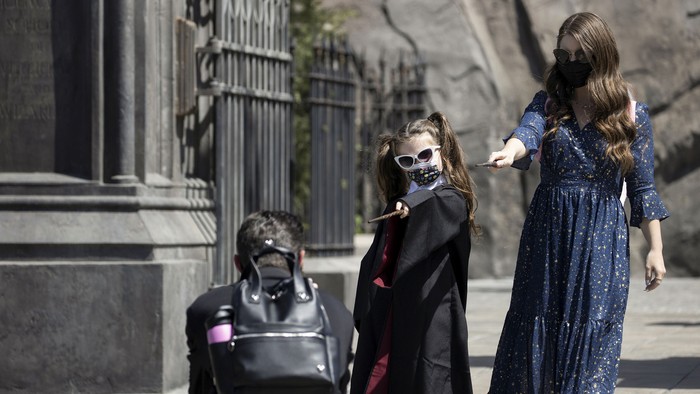 Guests pose for photos inside The Wizarding World Of Harry Potter area on reopening day of Universal Studios Hollywood during the outbreak of the coronavirus disease (COVID-19), in Universal City, California, U.S., April 15, 2021.  REUTERS/Mario Anzuoni
