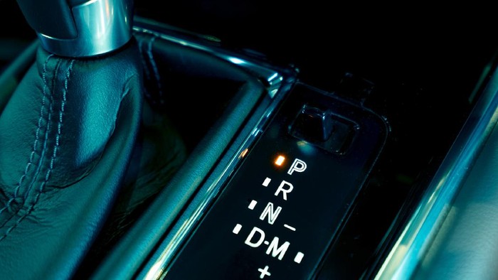 Automatic car gear stick. Automatic transmission gear shift inside modern and sport design car. Gear stick shift on parking mode position. Park-transmission locked in position for parking. Automotive.
