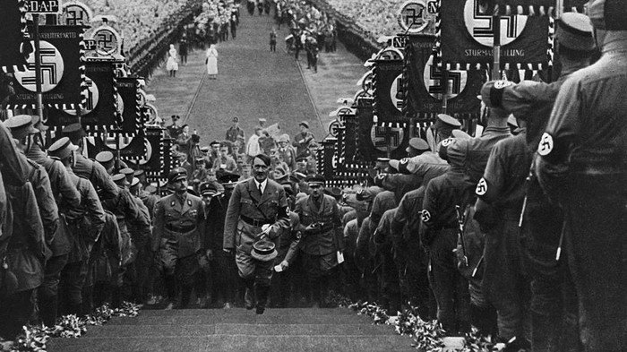 July 1945:  The alleged site of Adolf Hitlers grave behind the Chancellery in Berlin, with soldiers standing alongside the petrol cans thought to have been used to burn his body.