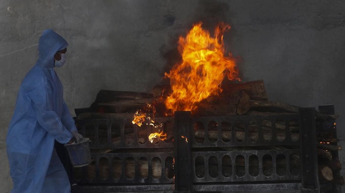 A COVID-19 victim is cremated in Vasai, outskirts of Mumbai, India, Thursday, April 15, 2021. India reported more than 200,000 new coronavirus cases Thursday, skyrocketing past 14 million overall as an intensifying outbreak puts a grim weight on its fragile health care system.
